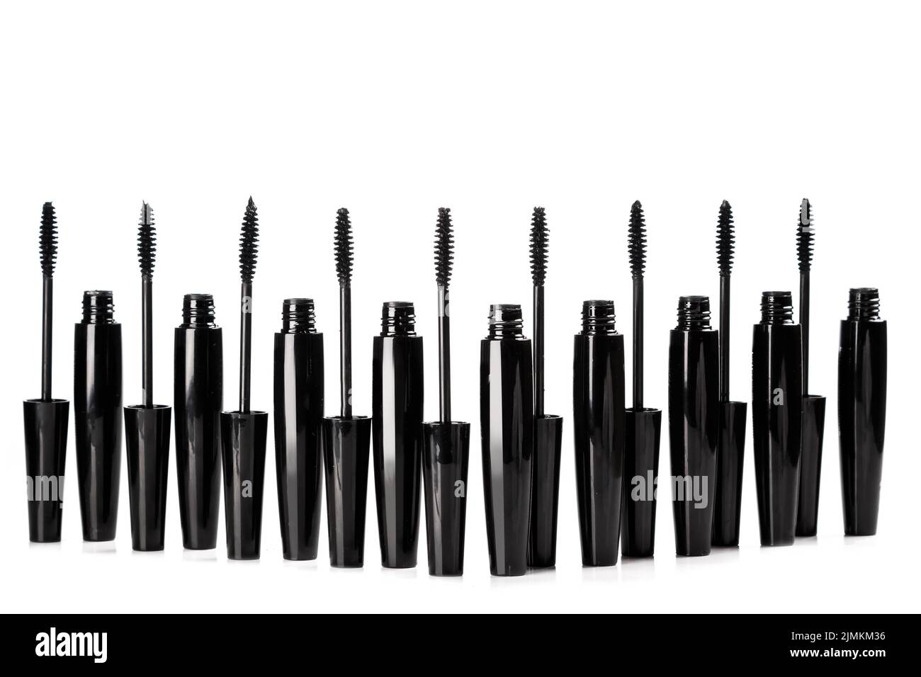 Black mascara brushes and containers on white background Stock Photo