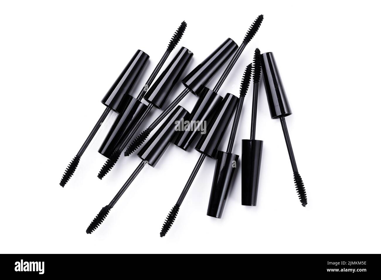 Black mascara brushes and containers on white background Stock Photo