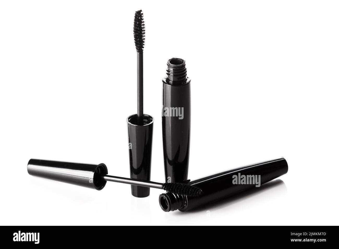 Black mascara brushes and containers on white background Stock Photo