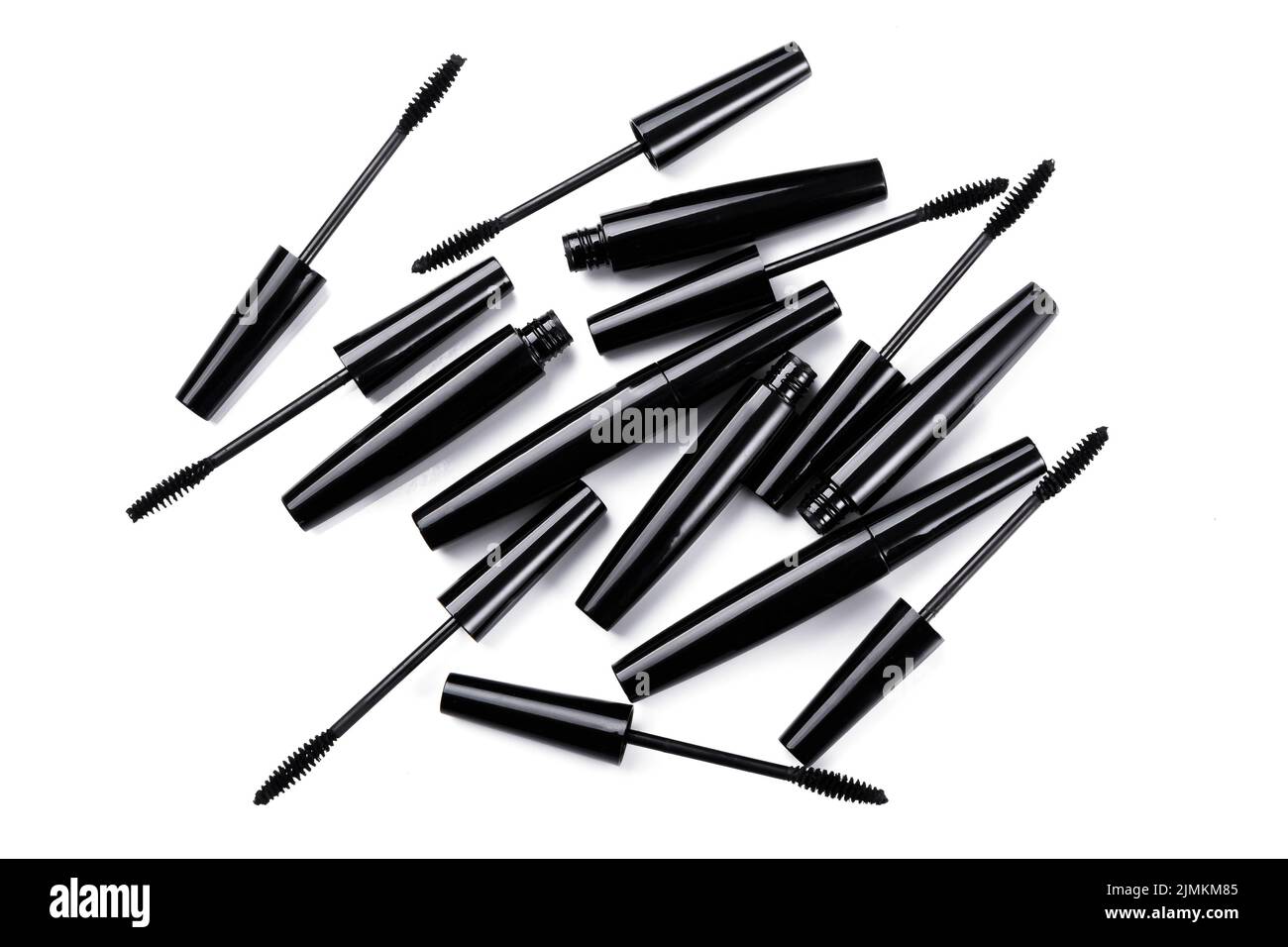 Black mascara brushes and containers on white background Stock Photo