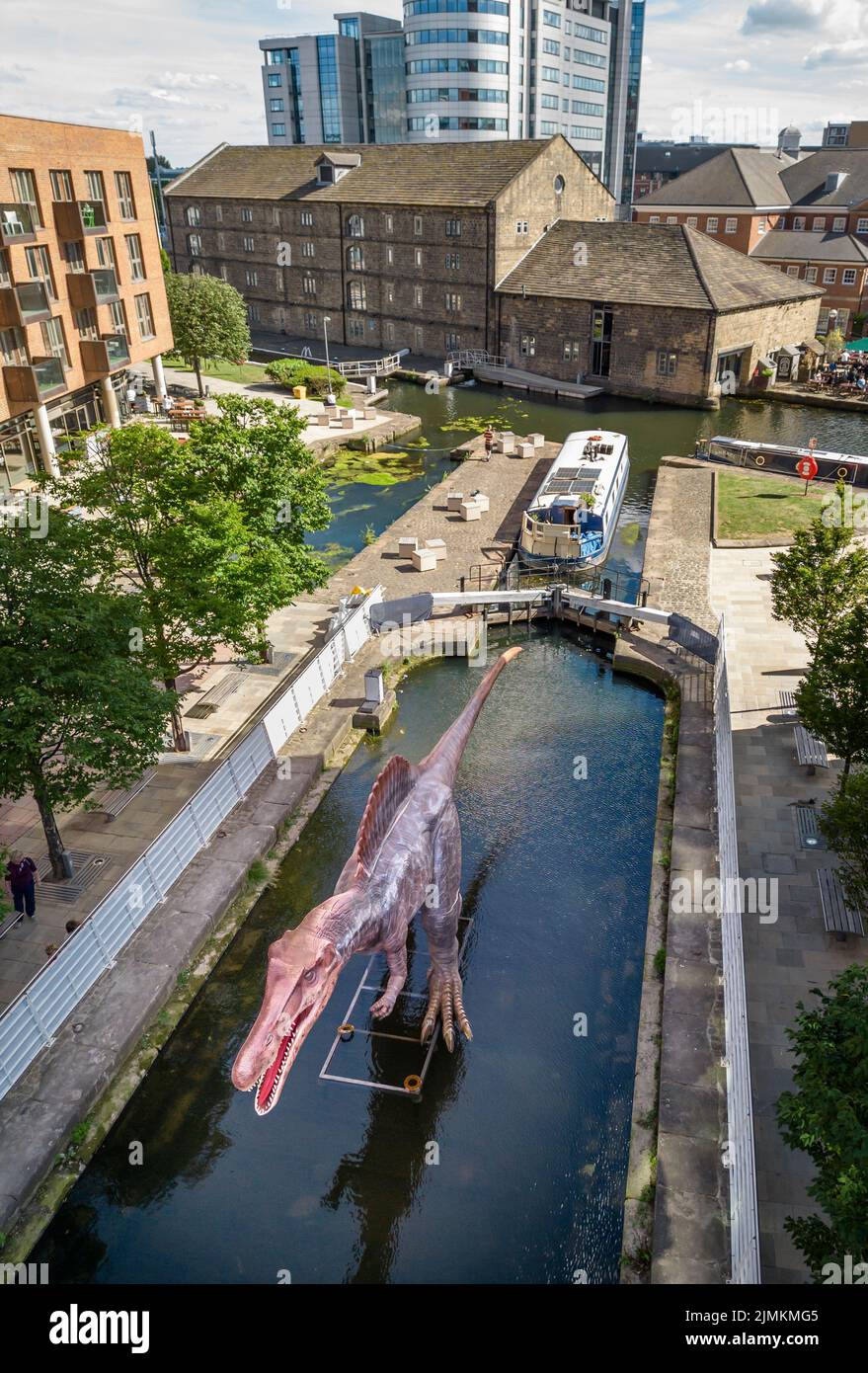 An animatronic Spinosaurus in the Leeds and Liverpool Canal at Granary Wharf in Leeds during the Leeds Jurassic Trail. Picture date: Thursday August 4, 2022. Stock Photo