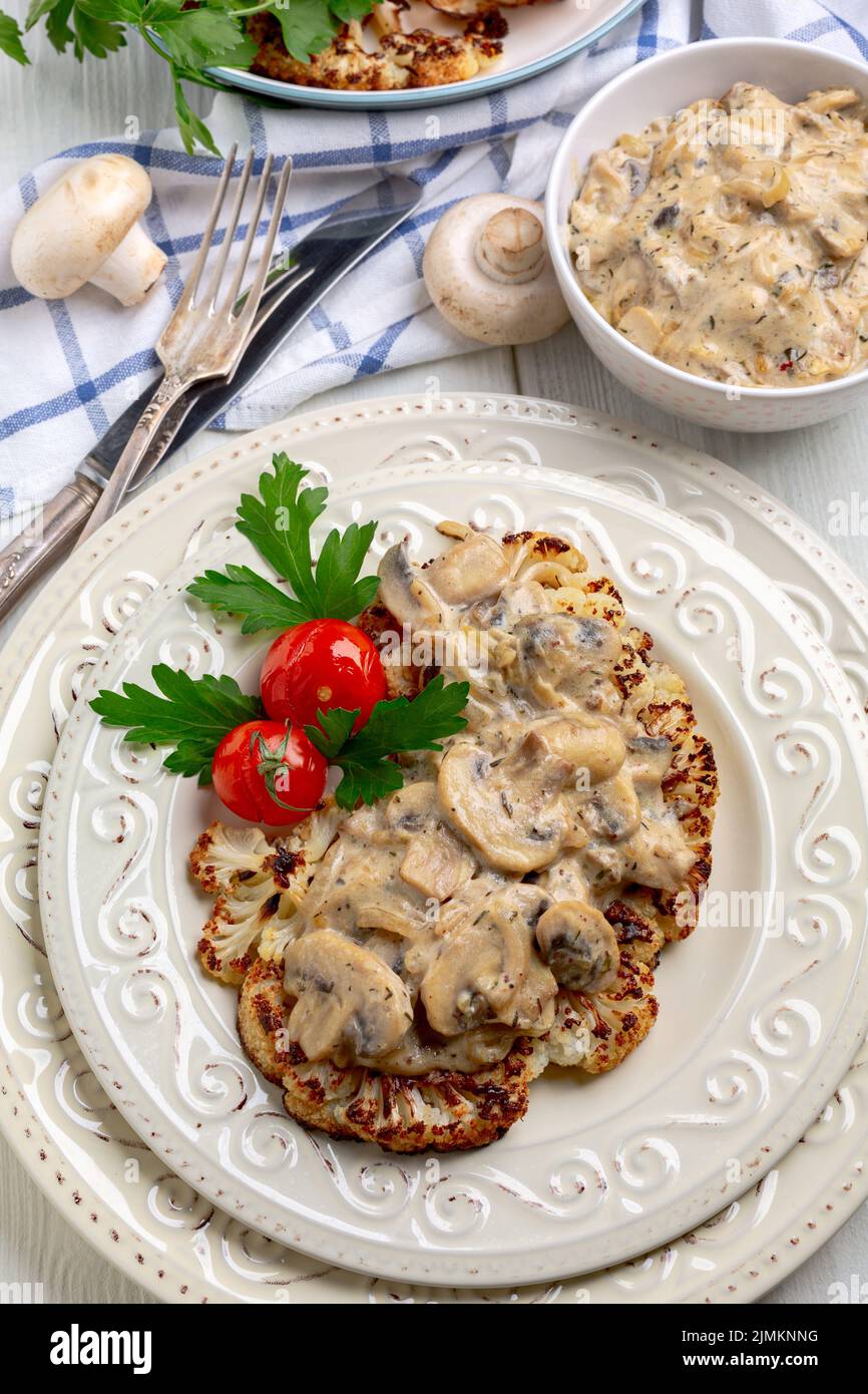 Cauliflower steak with mushrooms. Stock Photo