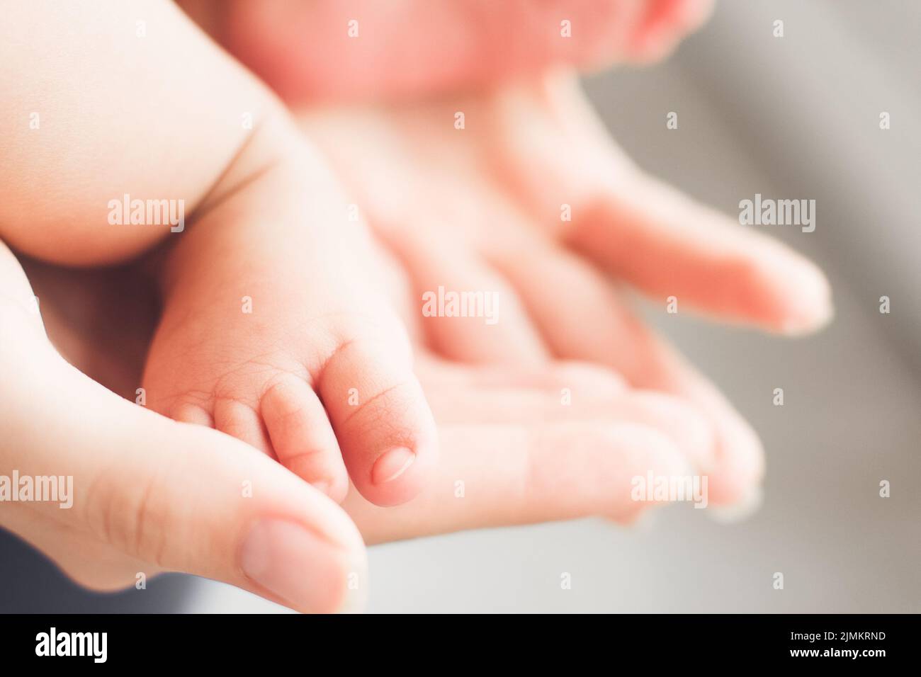 mother protection care love security baby feet Stock Photo - Alamy