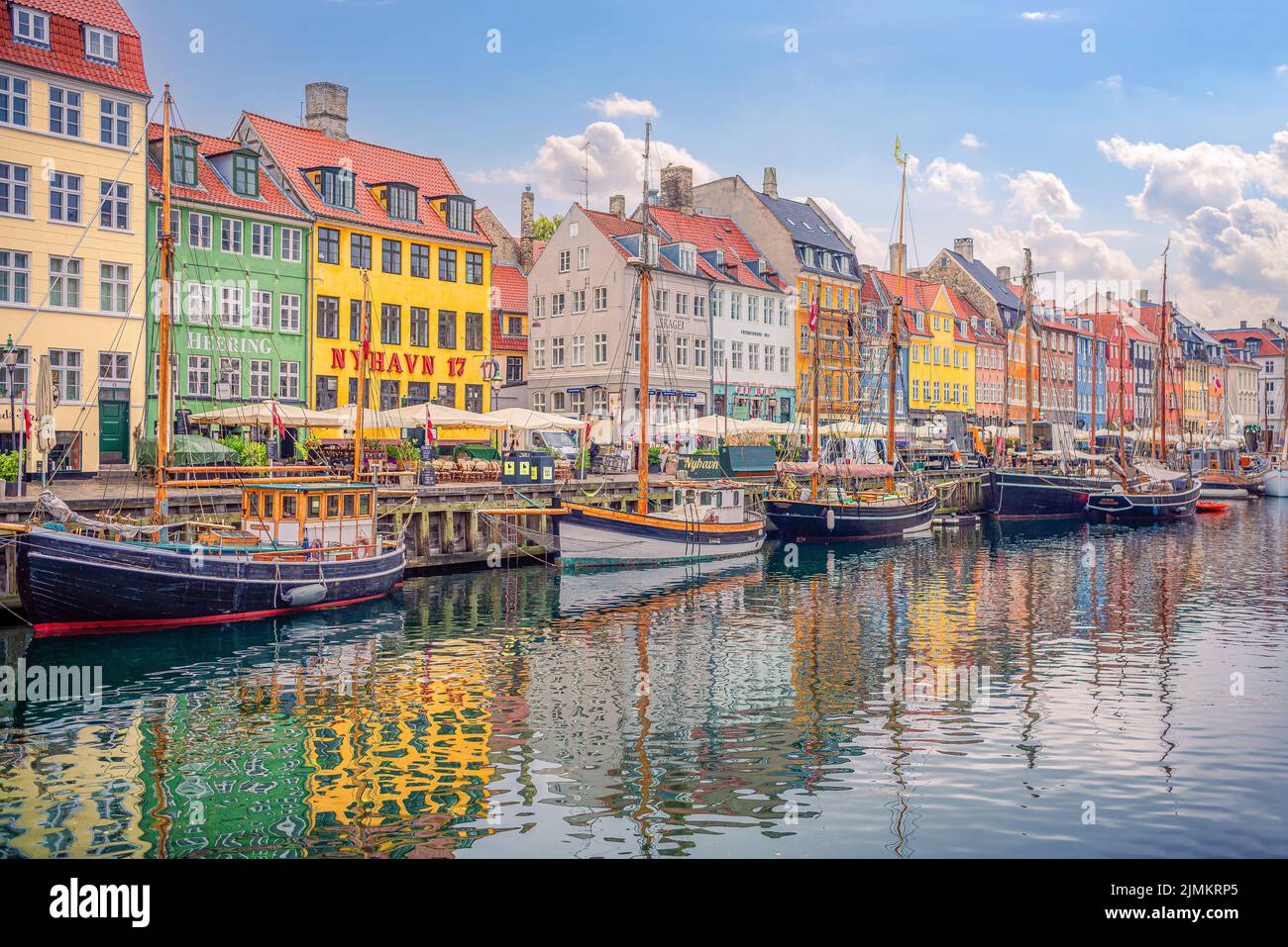 Many popular restaurants, cafes and bars in the old colorful houses on the Nyhavn waterfront. Copenhagen, Denmark. Stock Photo