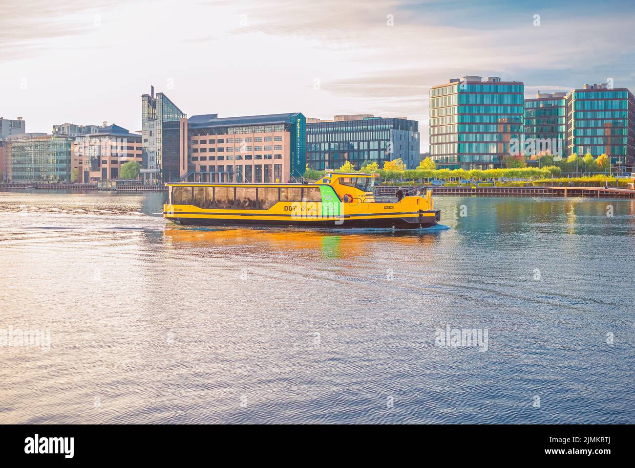 Yellow Copenhagen Harbour water Busesthe sails along the city canal  harbourfront near residential buildings of Copenhagen, Denm Stock Photo