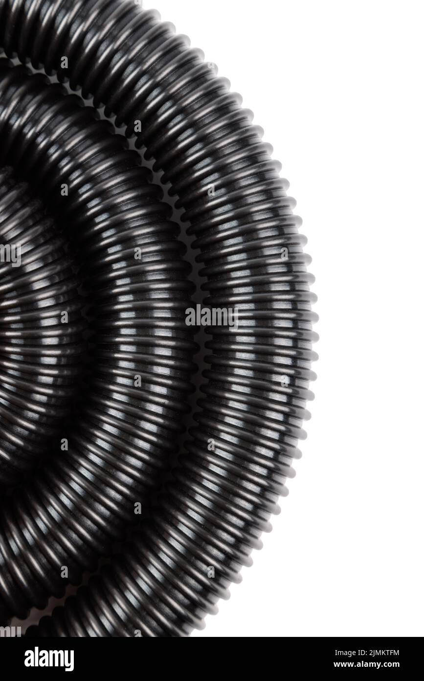 black plastic corrugated vacuum cleaner hose on white background Stock