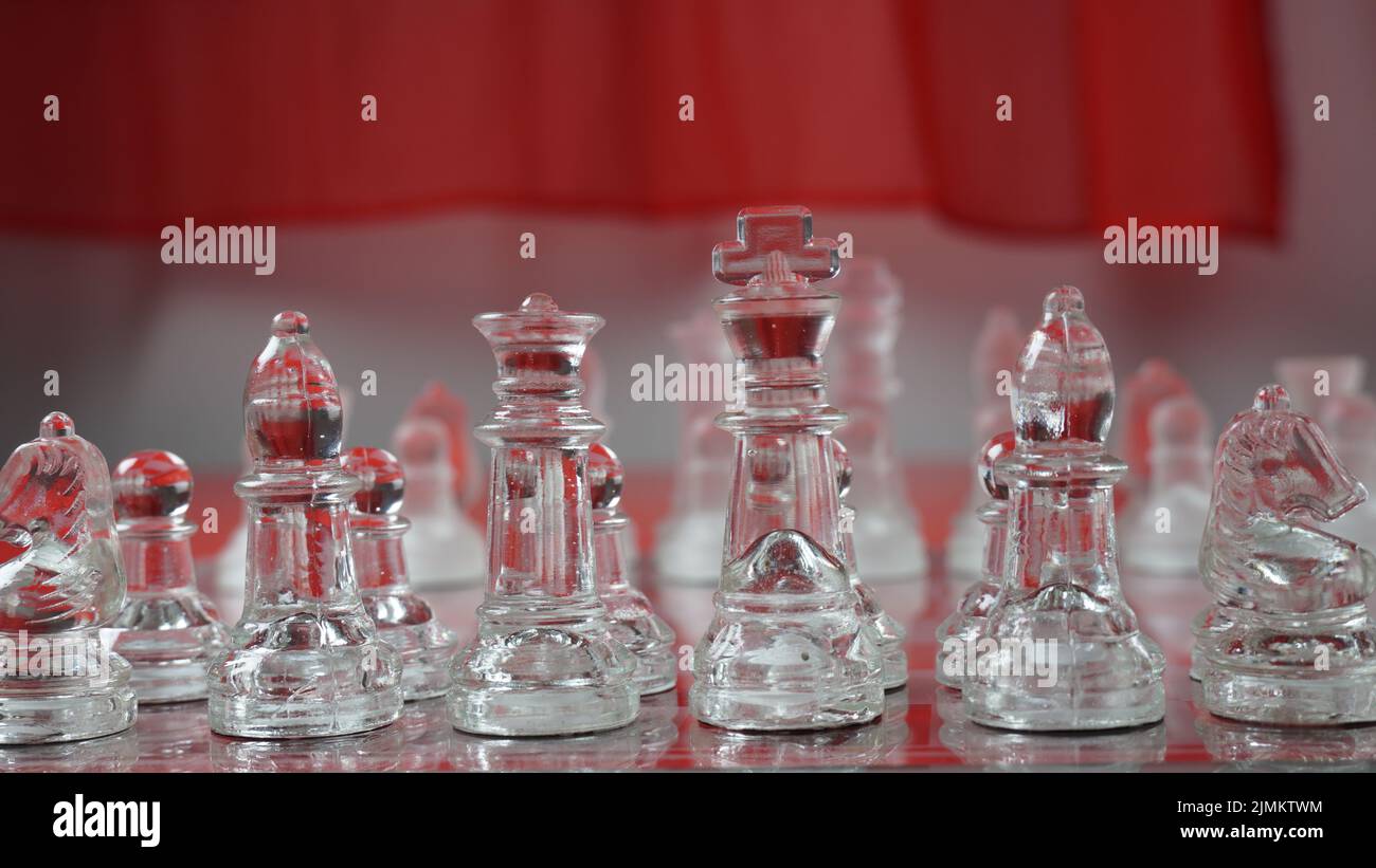 Transparent chess figures, on starting position, on reflective chess ...