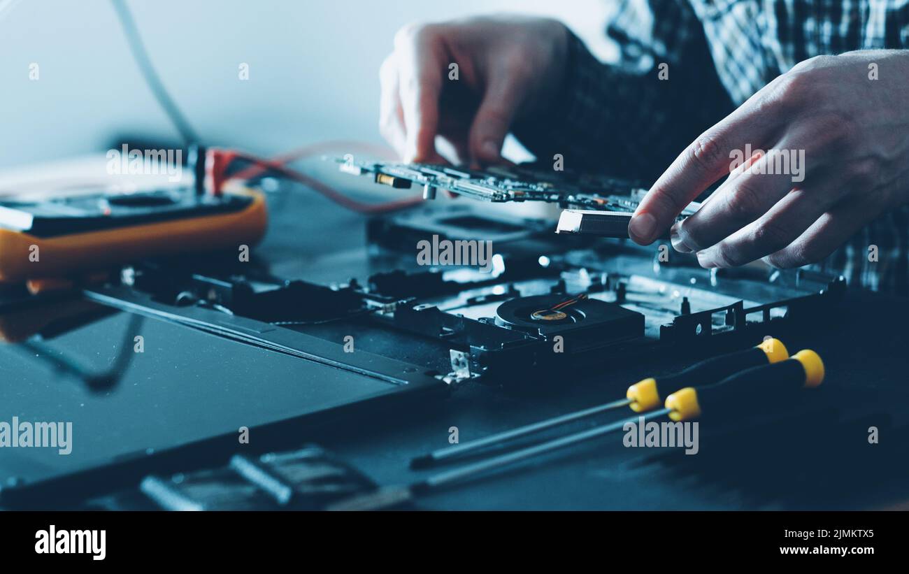 electronics repair shop male engineer laptop Stock Photo