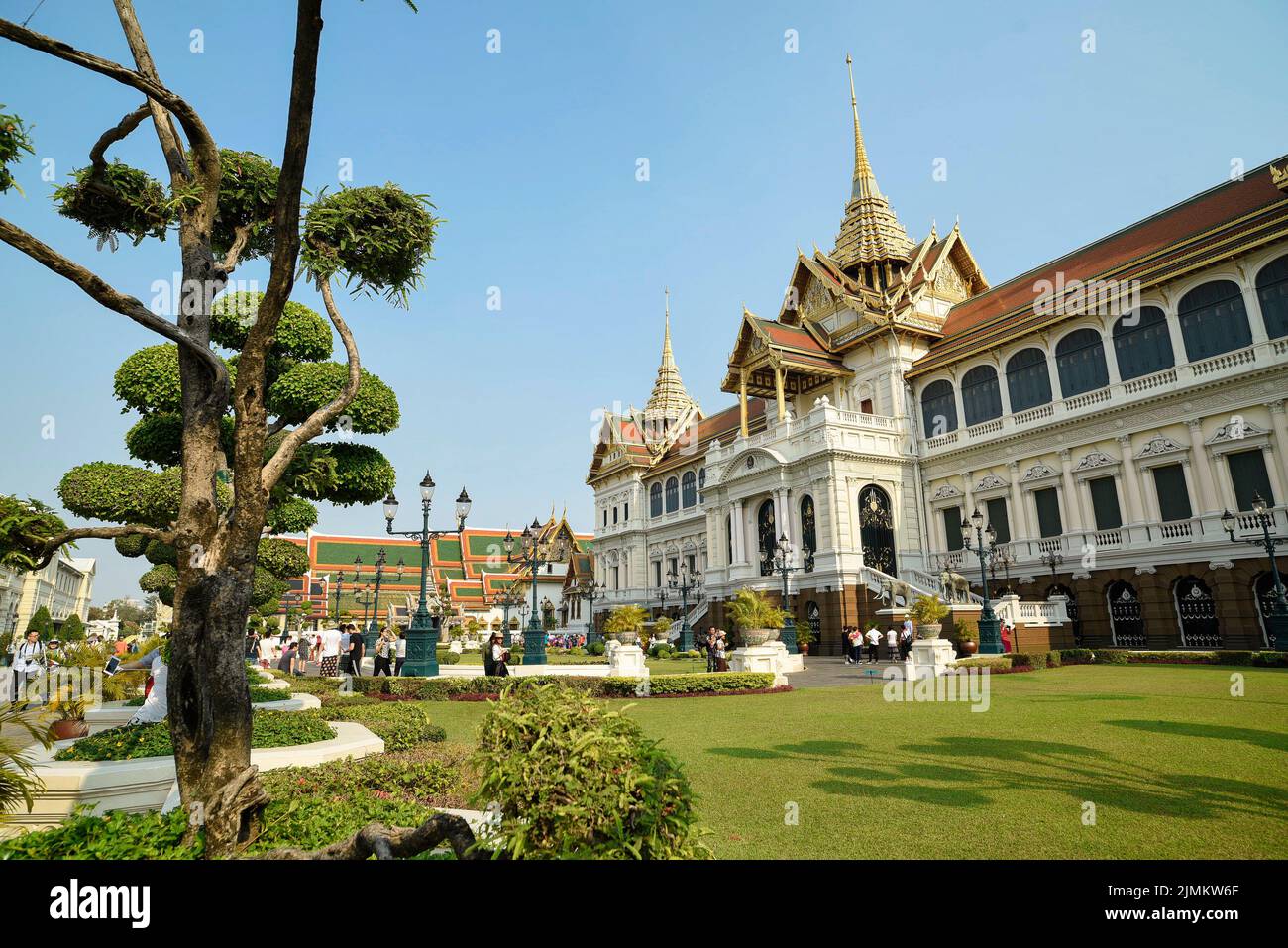 Famous Royal grand palace in Bangkok. Tourists visiting the temple. Stock Photo
