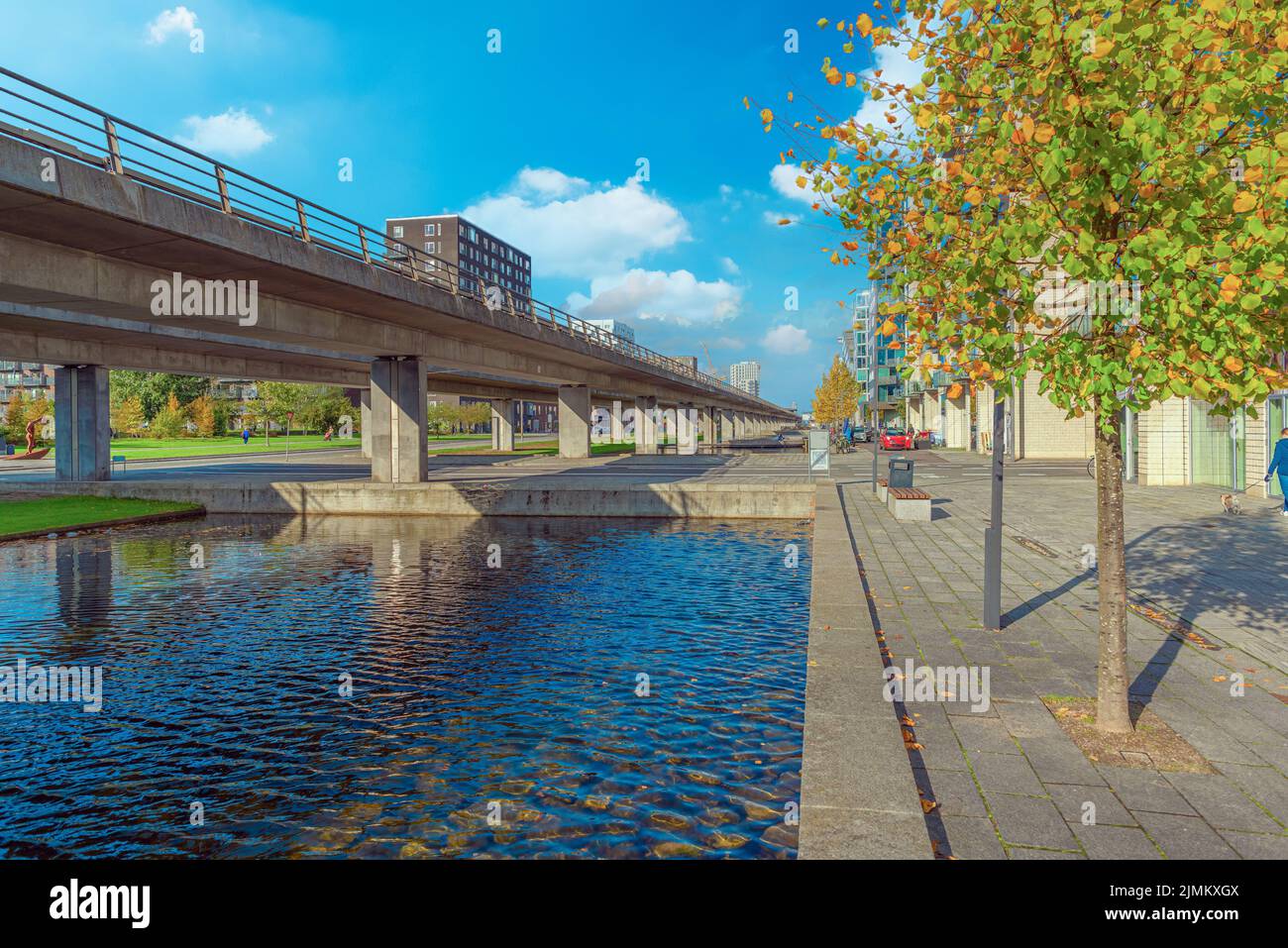 Water canal, metro line and pedestrian street near Ã˜restad boulevard in Copenhagen, Denmark Stock Photo