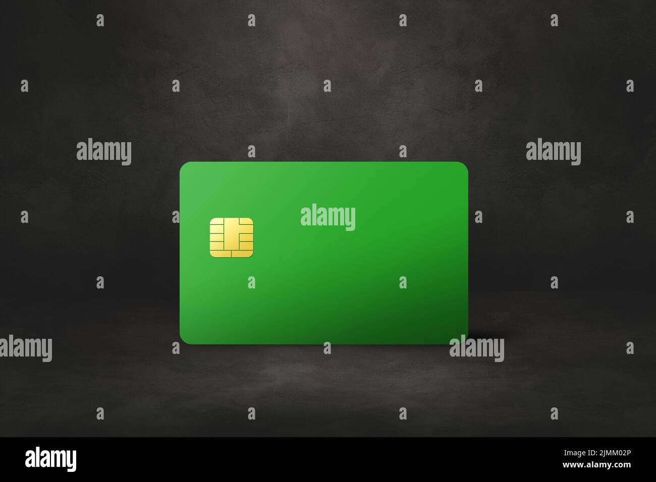 Green credit card on a black concrete background Stock Photo