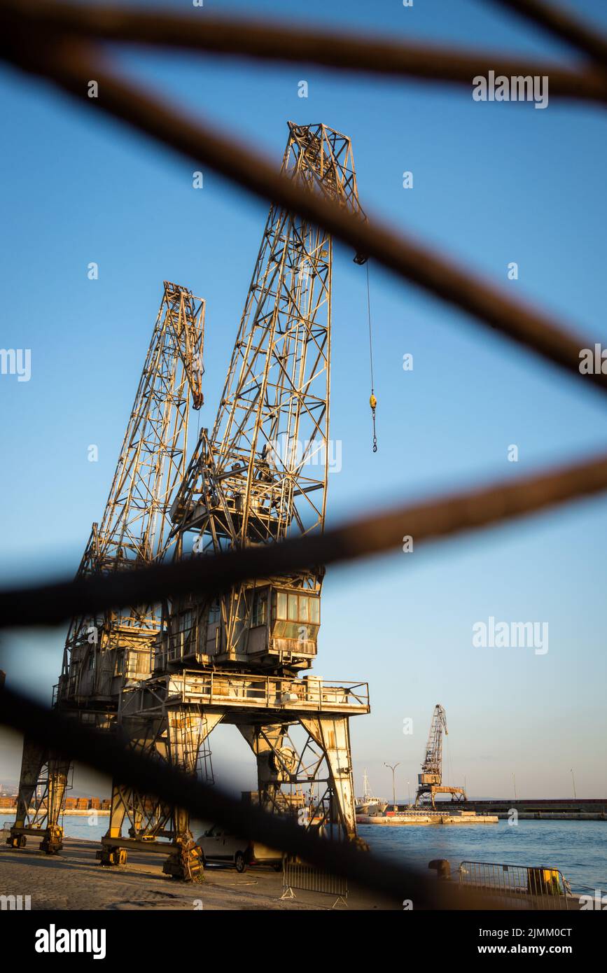 Cranes in the ship's port as silhouettes, in Rijeka in Croatia Stock Photo