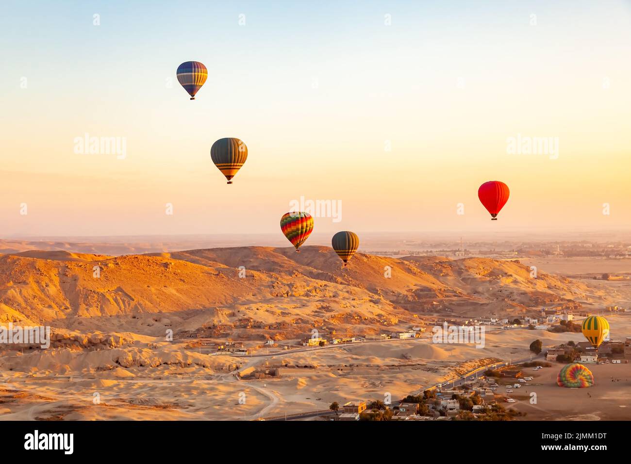 View of colorful hot air balloons flying over Valley of The Kings. Stock Photo