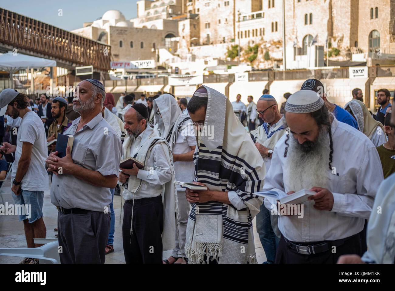 Jerusalem, Israel. 07th Aug, 2022. Jews pray at the Western Wall, known in Islam as the Buraq Wall, during the holy day Tisha B'Av, a day commemorating the destruction of ancient Jerusalem temples. Credit: Ilia Yefimovich/dpa/Alamy Live News Stock Photo