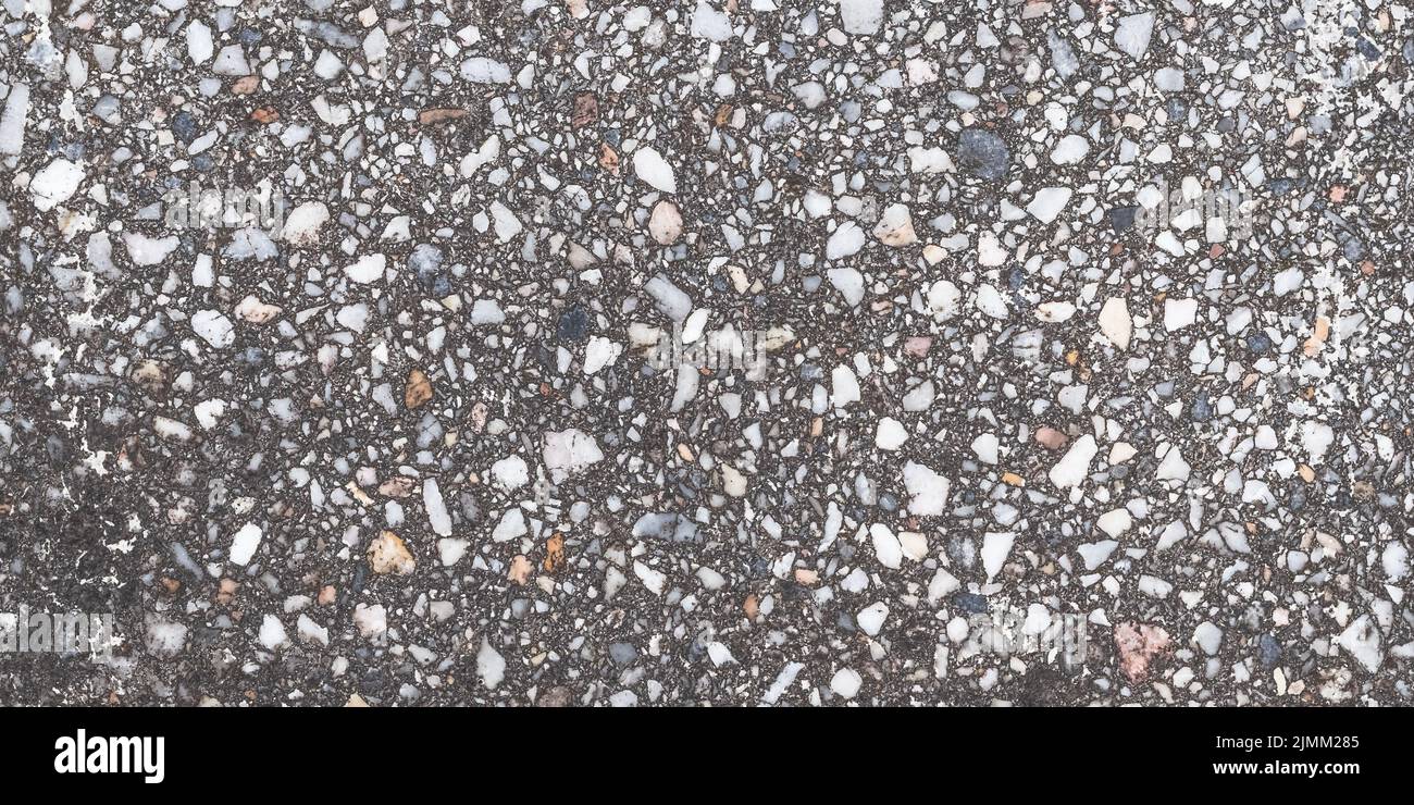 Granite texture, natural gray pattern of tiles floor for design, grainy surface of pavement. Abstract dark stones background. Old weathered urban wall Stock Photo