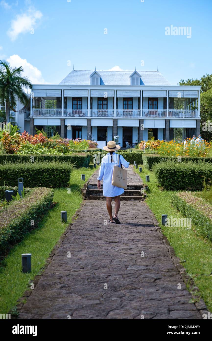 Le Chateau de Bel Ombre Mauritius, old castle in tropical garden in Mauritius, woman walking in a garden of an old castle Stock Photo