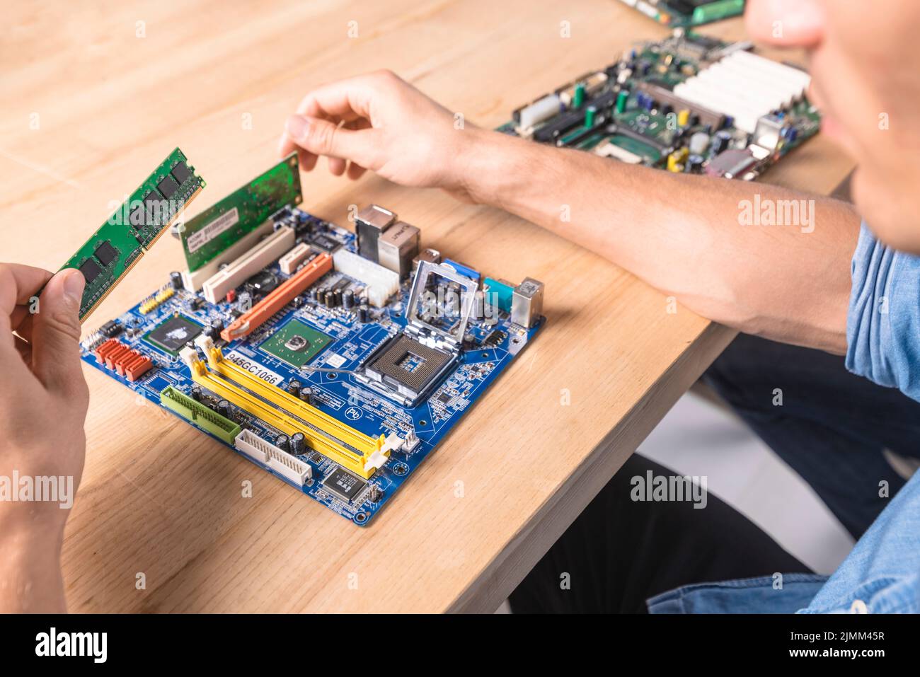 Engineer putting ram memory module motherboard Stock Photo