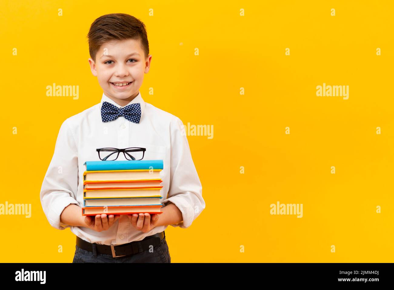 Copy space boy holding stack books Stock Photo