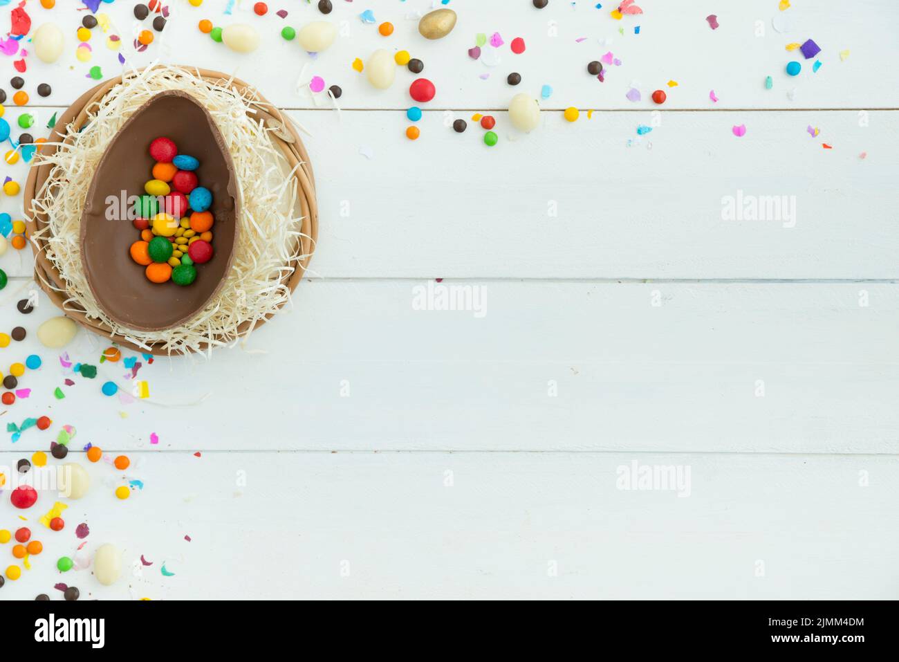 Small candies open easter chocolate egg table Stock Photo