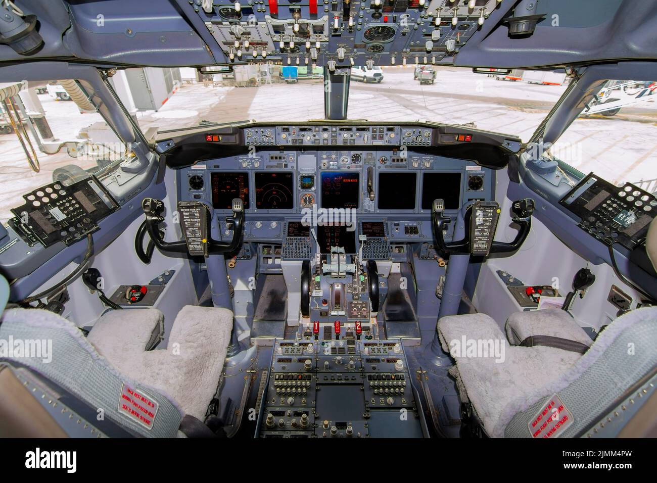 A view of the cockpit of a large commercial airplane a cockpit . Cockpit view of a commercial aircraft cruising Control panel in a plane cockpit. Stock Photo