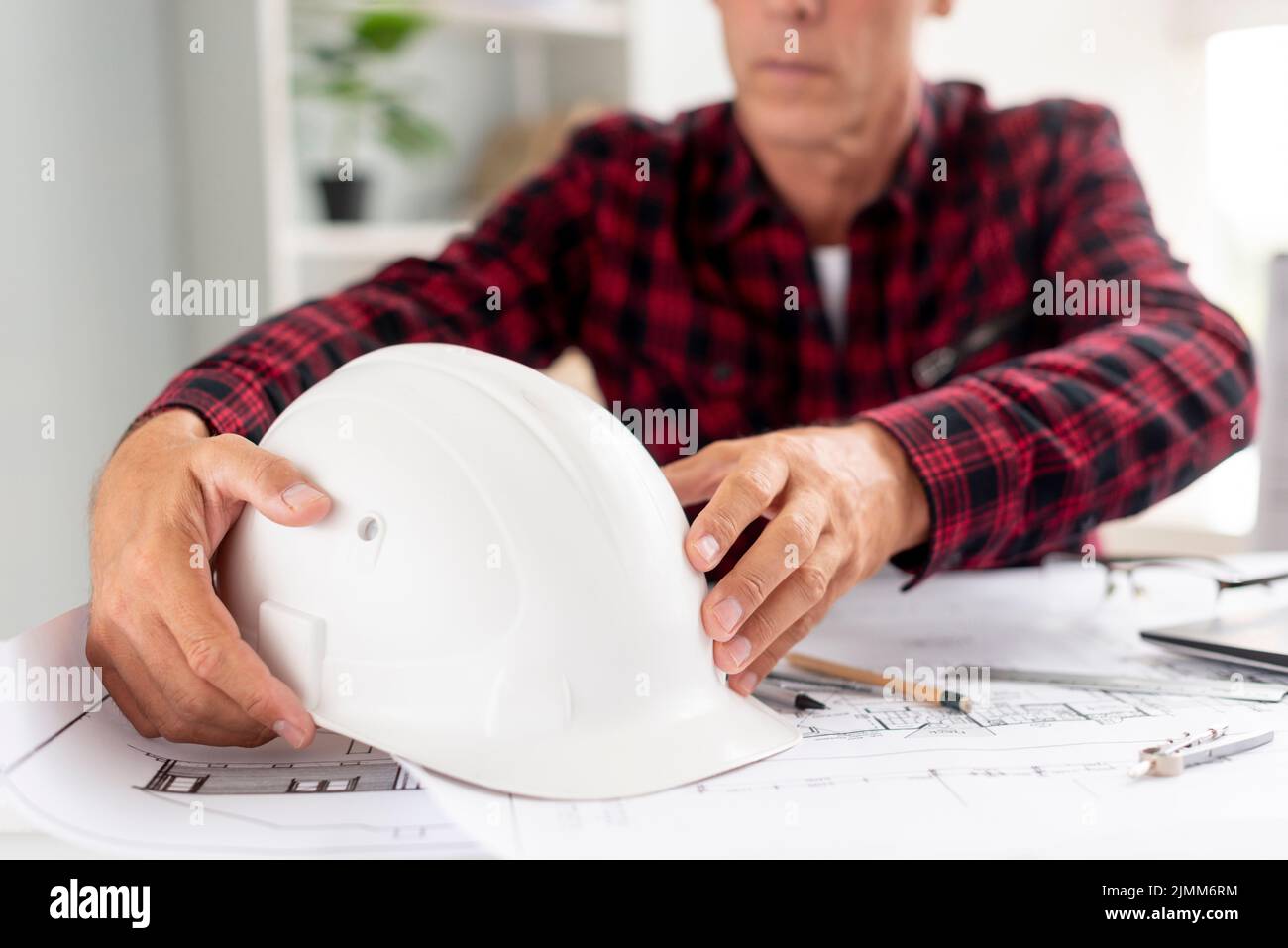 Architect holding his safety helmet Stock Photo