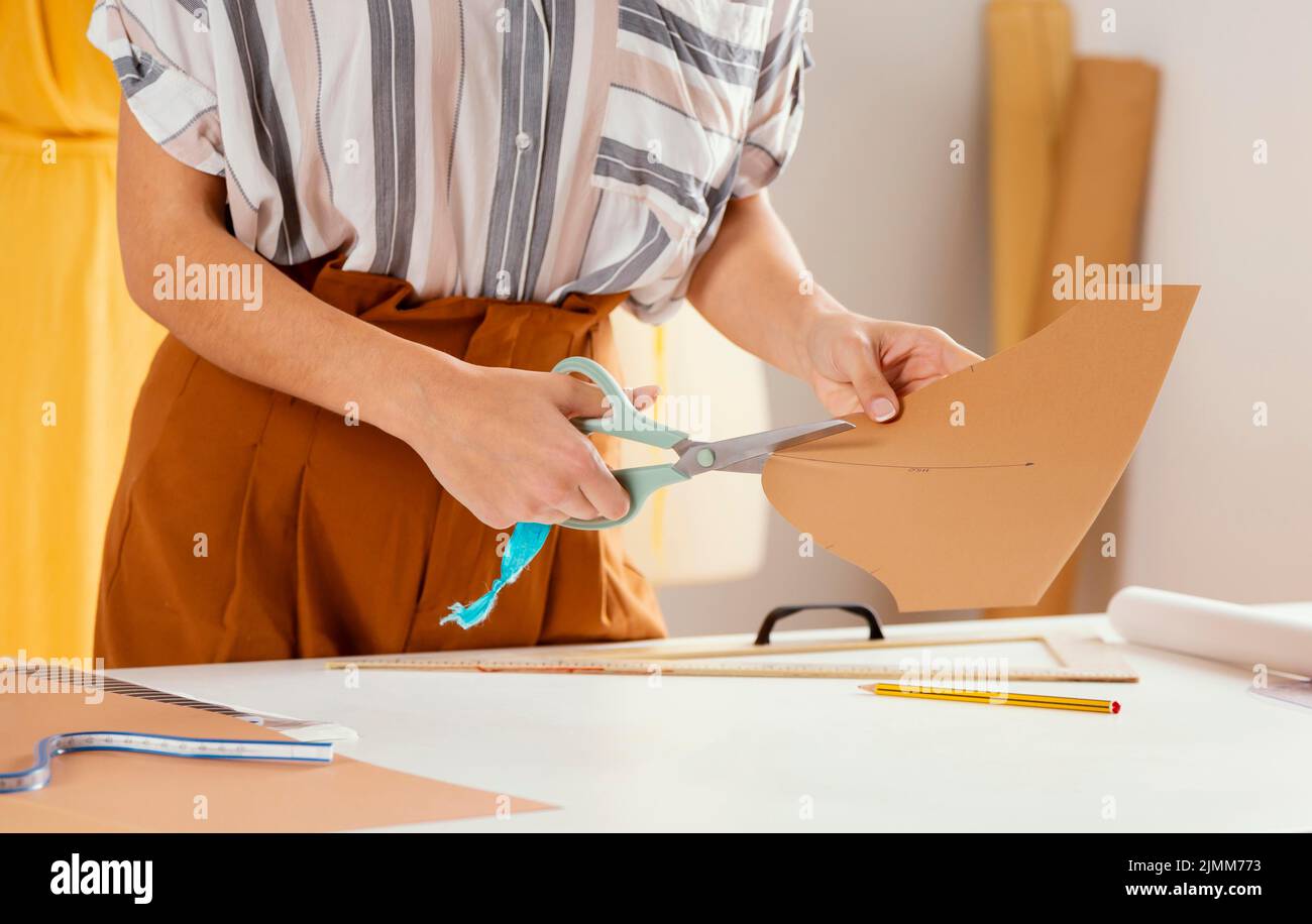 Close up hand cutting paper Stock Photo Alamy