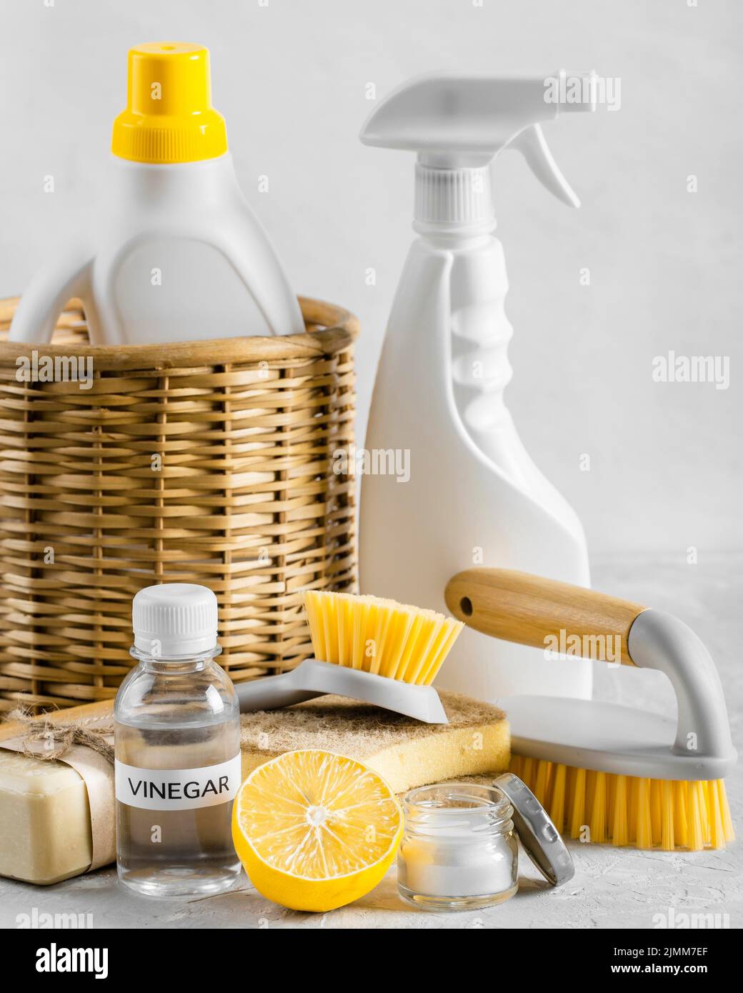 Front view eco friendly cleaning brushes basket with lemon vinegar Stock Photo