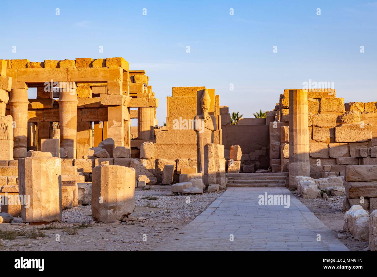 Statue of Pharaoh Ramses II standing in front of the ruins temple Stock ...