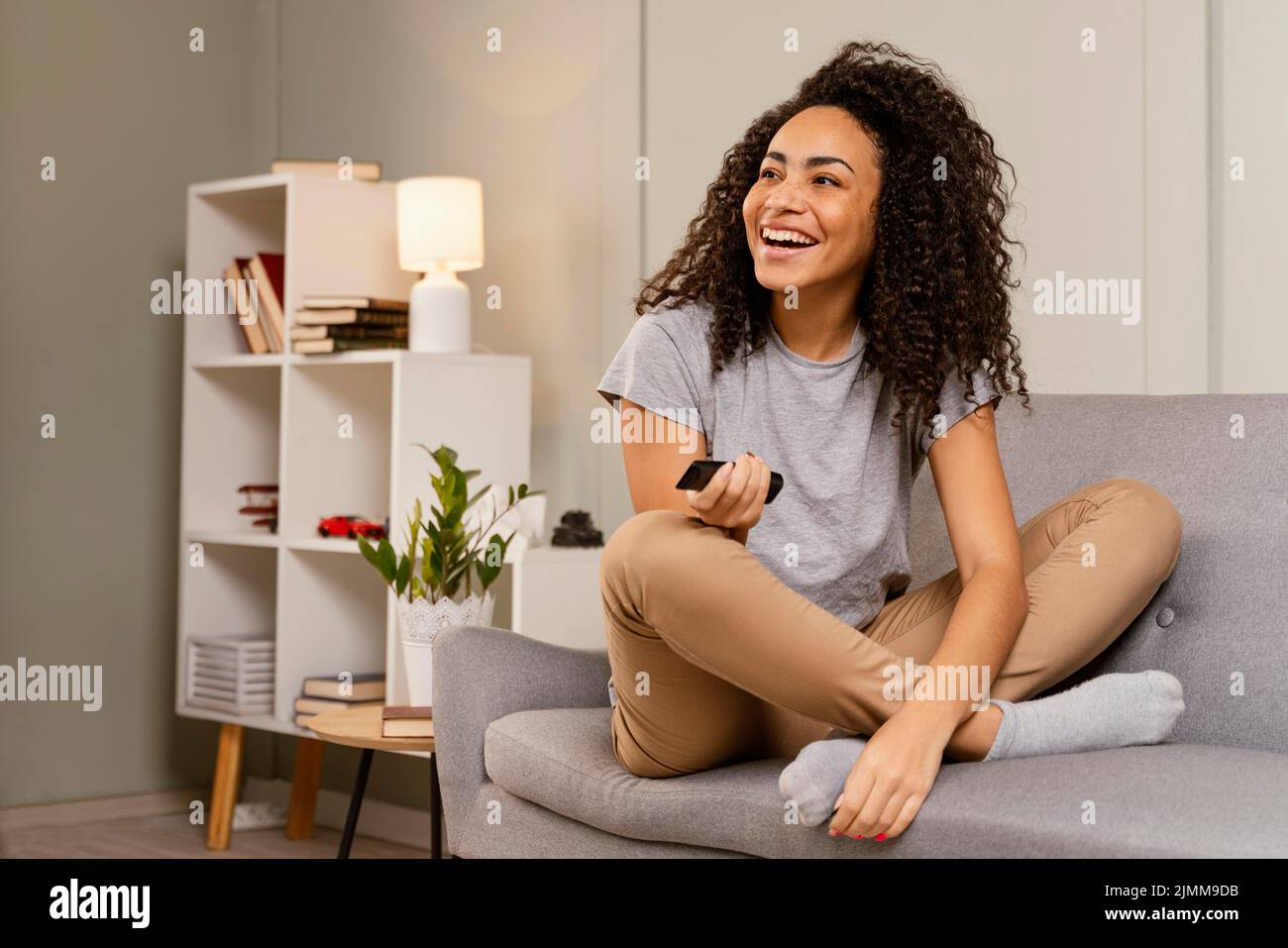 Woman couch watching tv Stock Photo