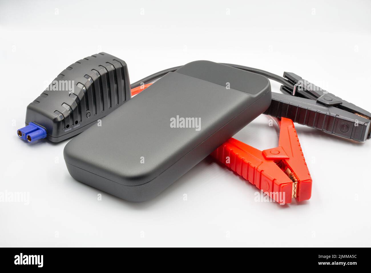 Portable car jump starter closeup on white. Emergency charger booster Modern power bank battery. Stock Photo