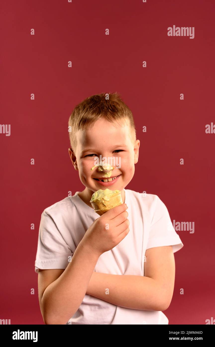 Portrait happy young boy eating ice cream Stock Photo