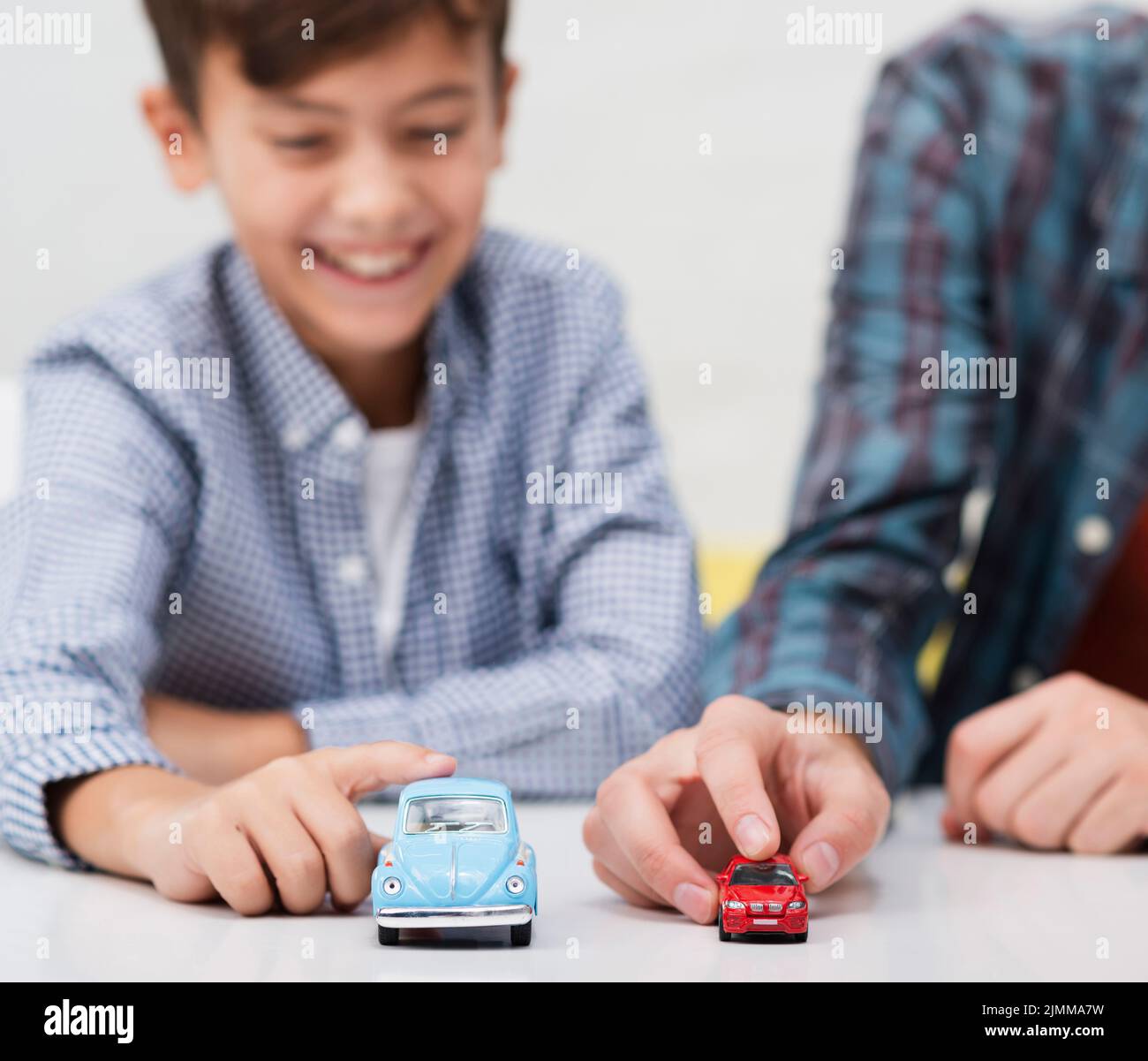 Smiling little boy playing with toy cars Stock Photo Alamy