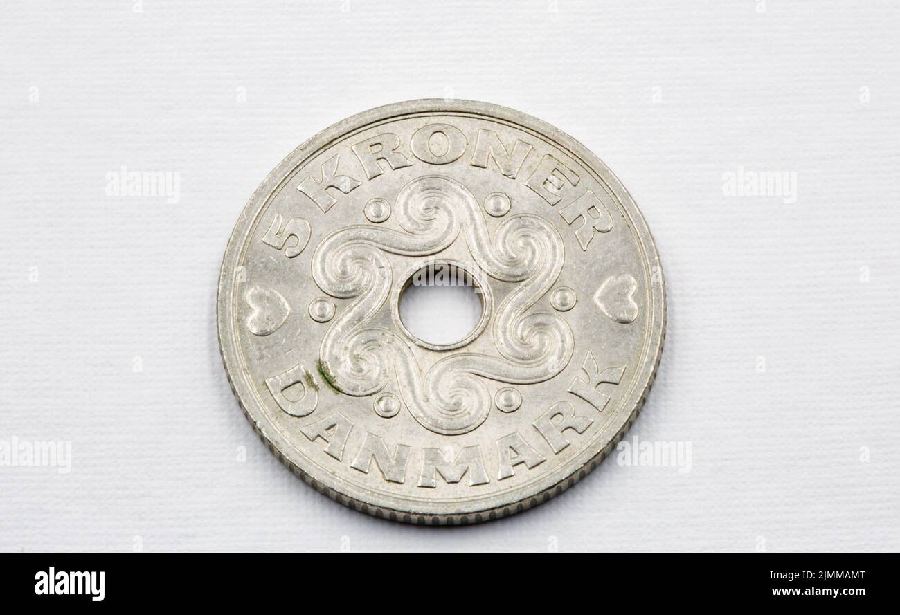Danish krone coinscloseup on white. The krone is the official currency of Denmark, Greenland, and the Faroe Islands, introduced on 1 January 1875. Stock Photo
