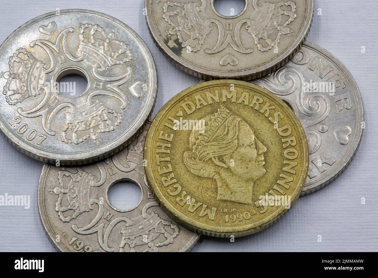 Danish krone coins closeup on white. The krone is the official currency of Denmark, Greenland, and the Faroe Islands, introduced on 1 January 1875. Stock Photo