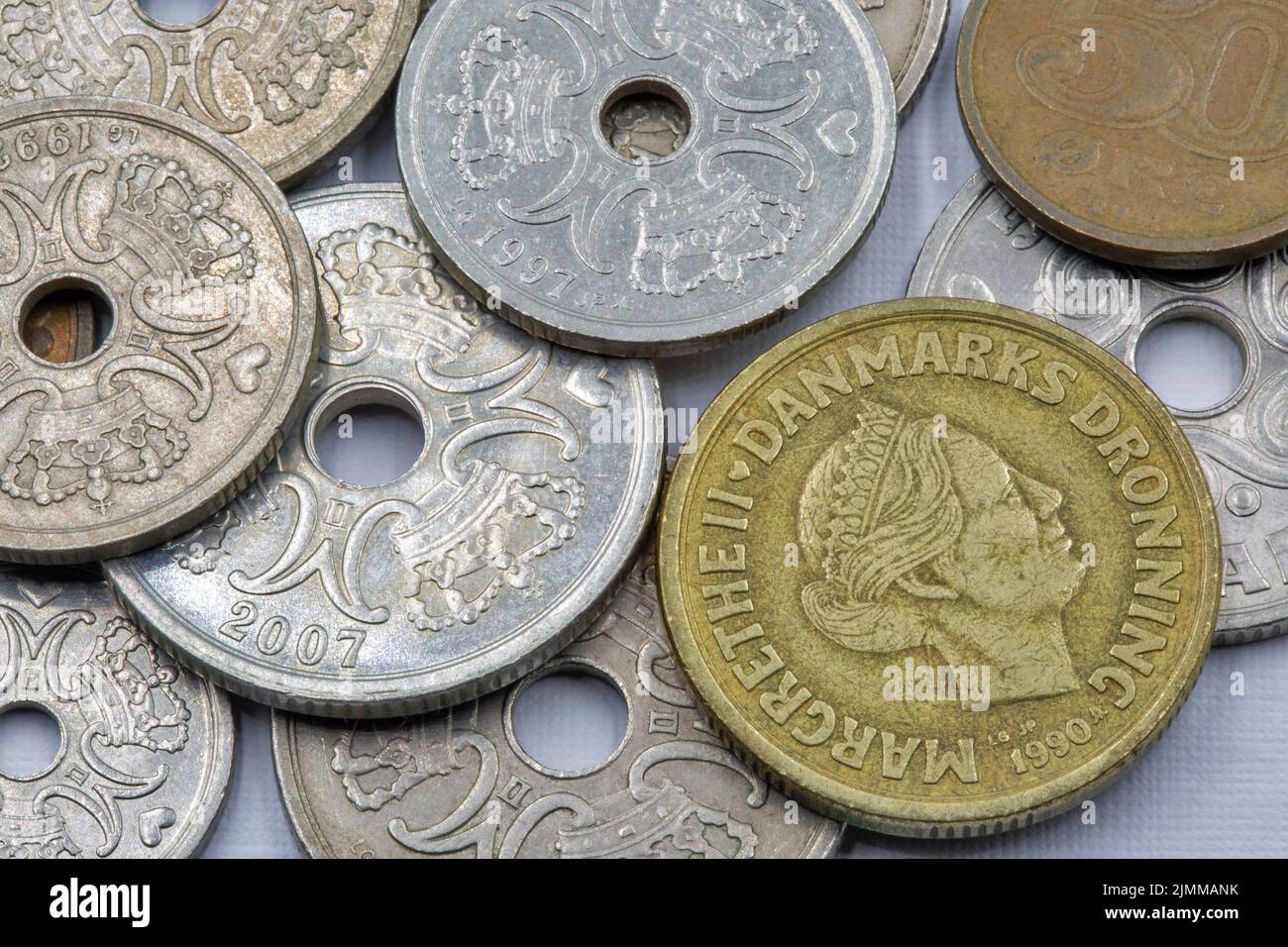 Danish krone coins closeup on white. The krone is the official currency of Denmark, Greenland, and the Faroe Islands, introduced on 1 January 1875. Stock Photo