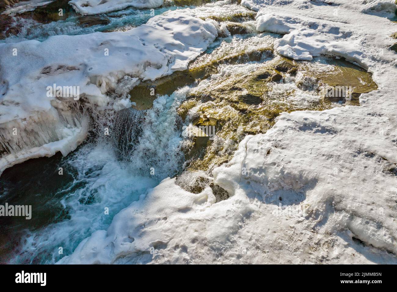 Winter Probiy waterfall closeup on the Prut River, in Yaremche, Ivano-Frankivsk region, Carpathian mountains, Ukraine. Stock Photo