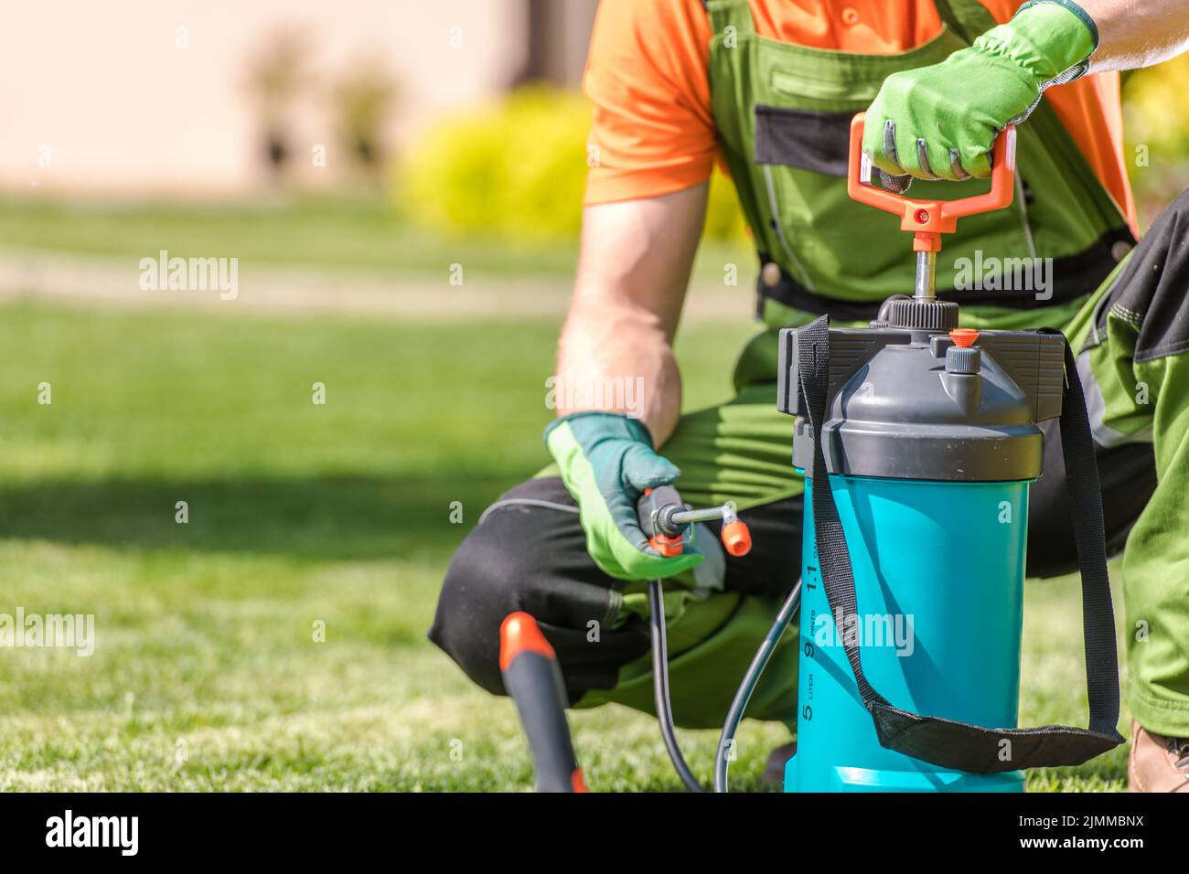 Closeup of Garden Pressure Sprayer. Professional Gardener Preparing to