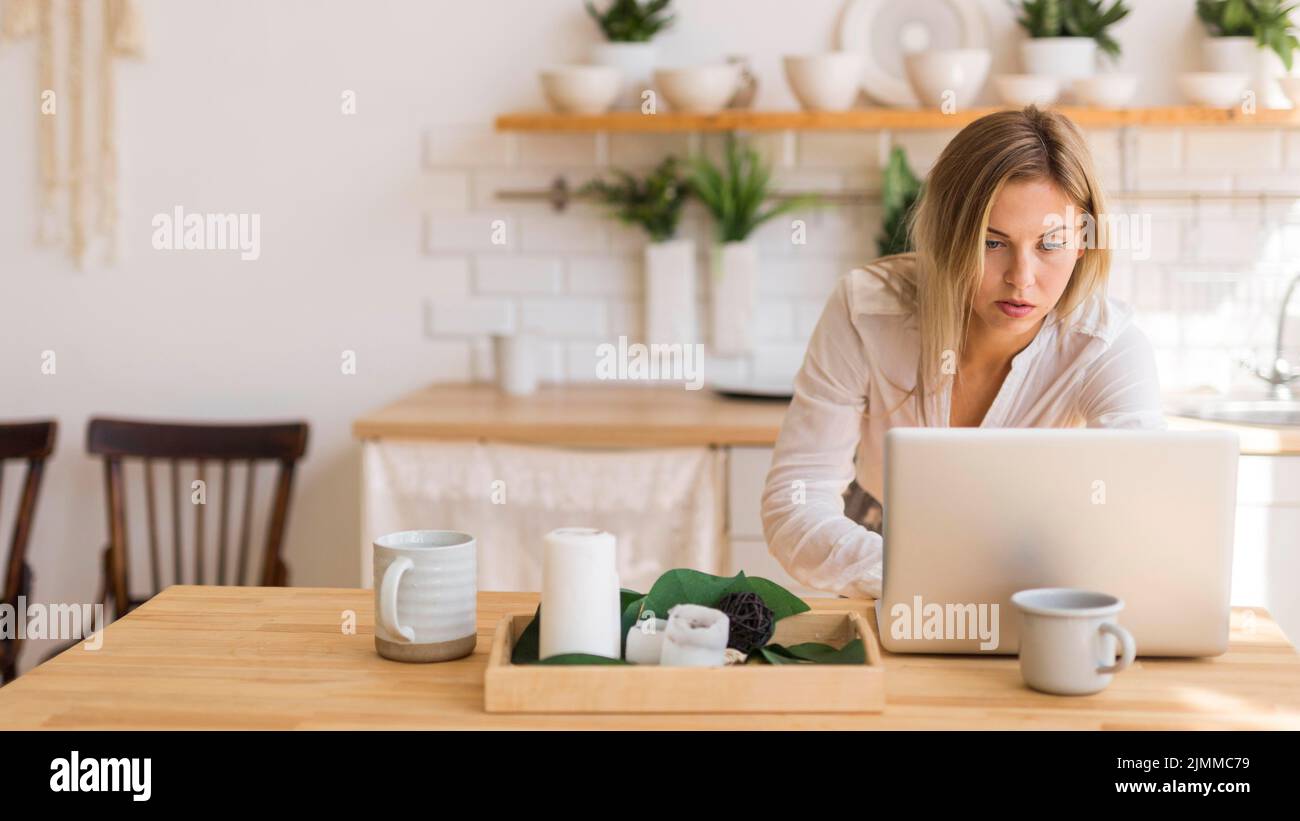 Medium shot woman working from home Stock Photo