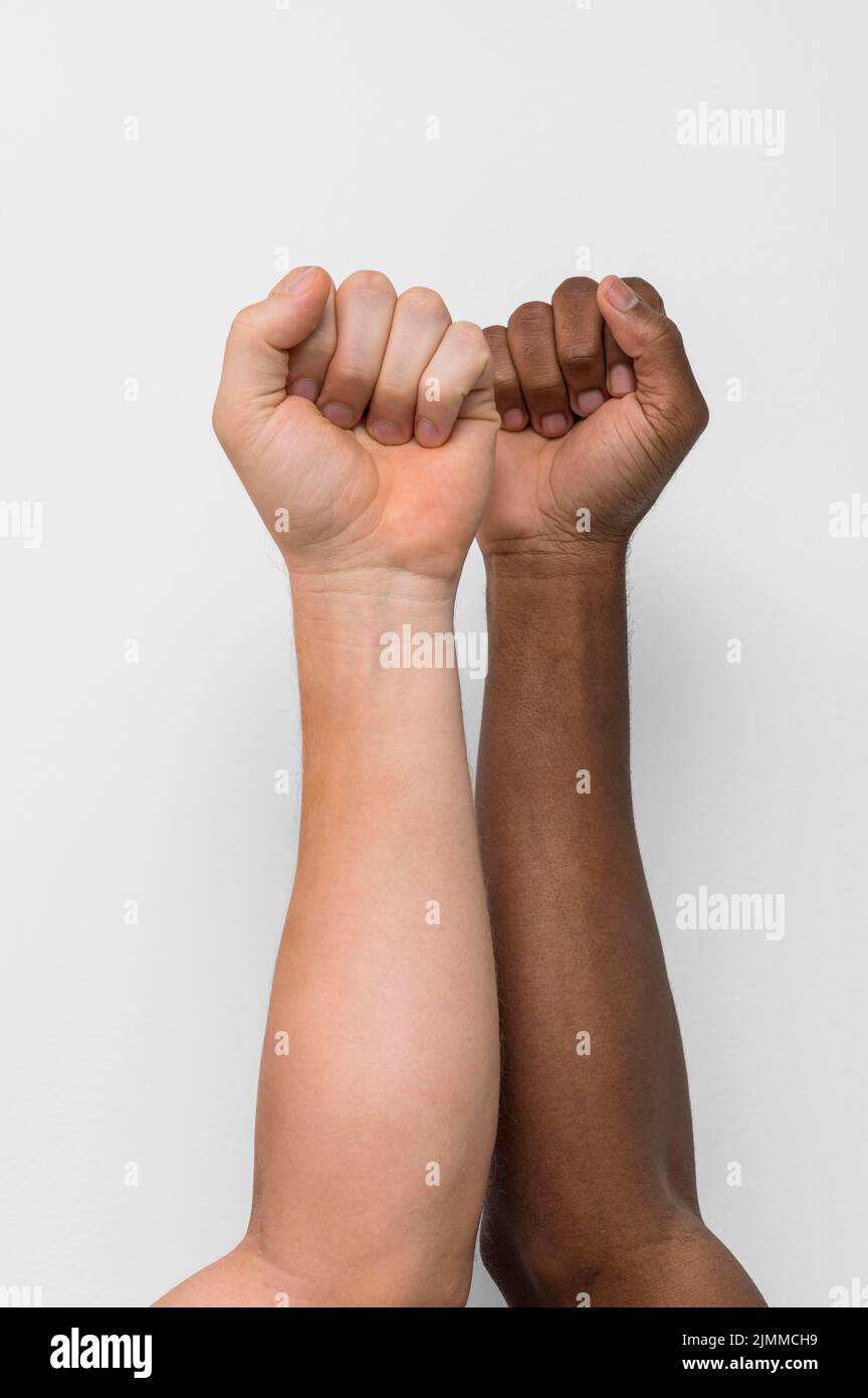 Multiracial hands coming together Stock Photo