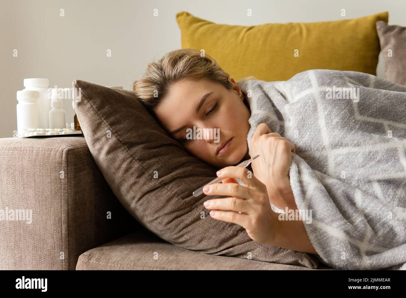 Sick woman is sleeping under the blanket at home Stock Photo Alamy