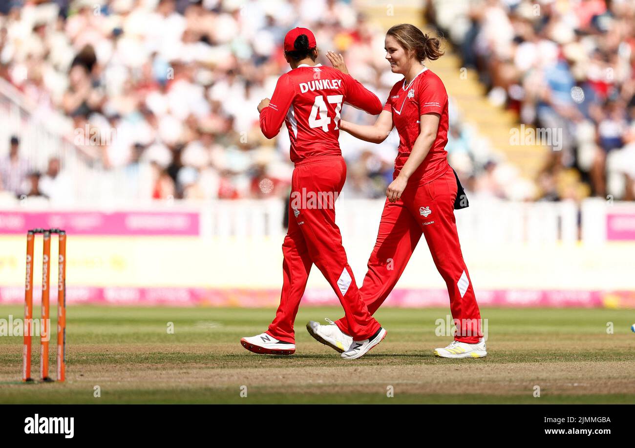 Commonwealth Games - Women's Cricket T20 - England v New Zealand - Bronze Medal - Edgbaston Stadium, Britain - August 7, 2022 England's Nat Sciver celebrates with Sophia Dunkley after taking the wicket of New Zealand's Suzie Bates REUTERS/Jason Cairnduff Stock Photo