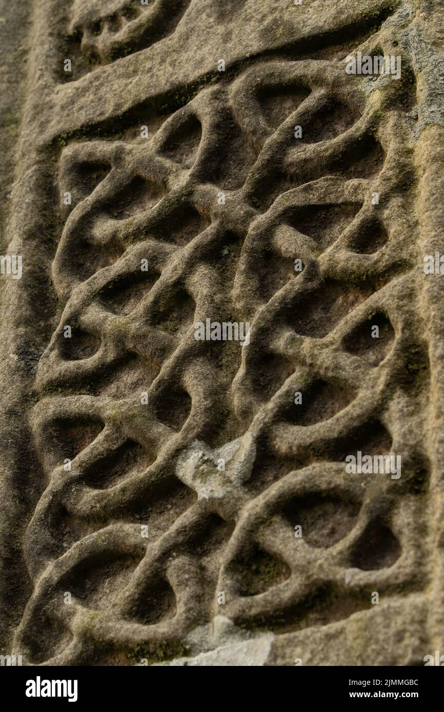 Detail from the Bewcastle Cross - Anglo Saxon interlace knot carving, 7th or 8th century, in St Cuthbert's churchyard, Bewcastle, Cumbria, UK. Stock Photo