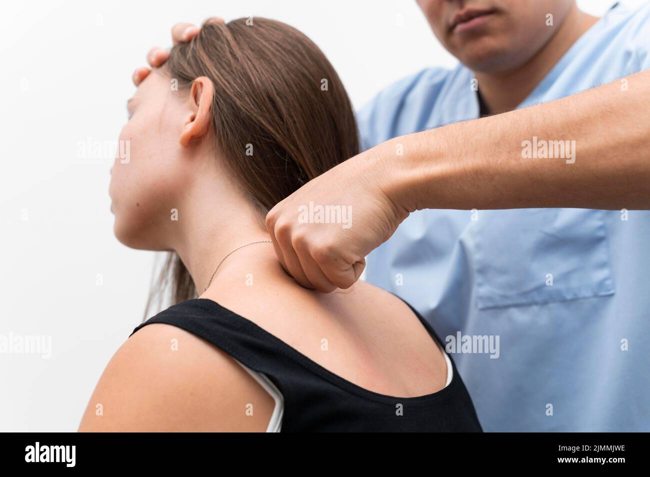 Physiotherapist massaging woman s upper back Stock Photo