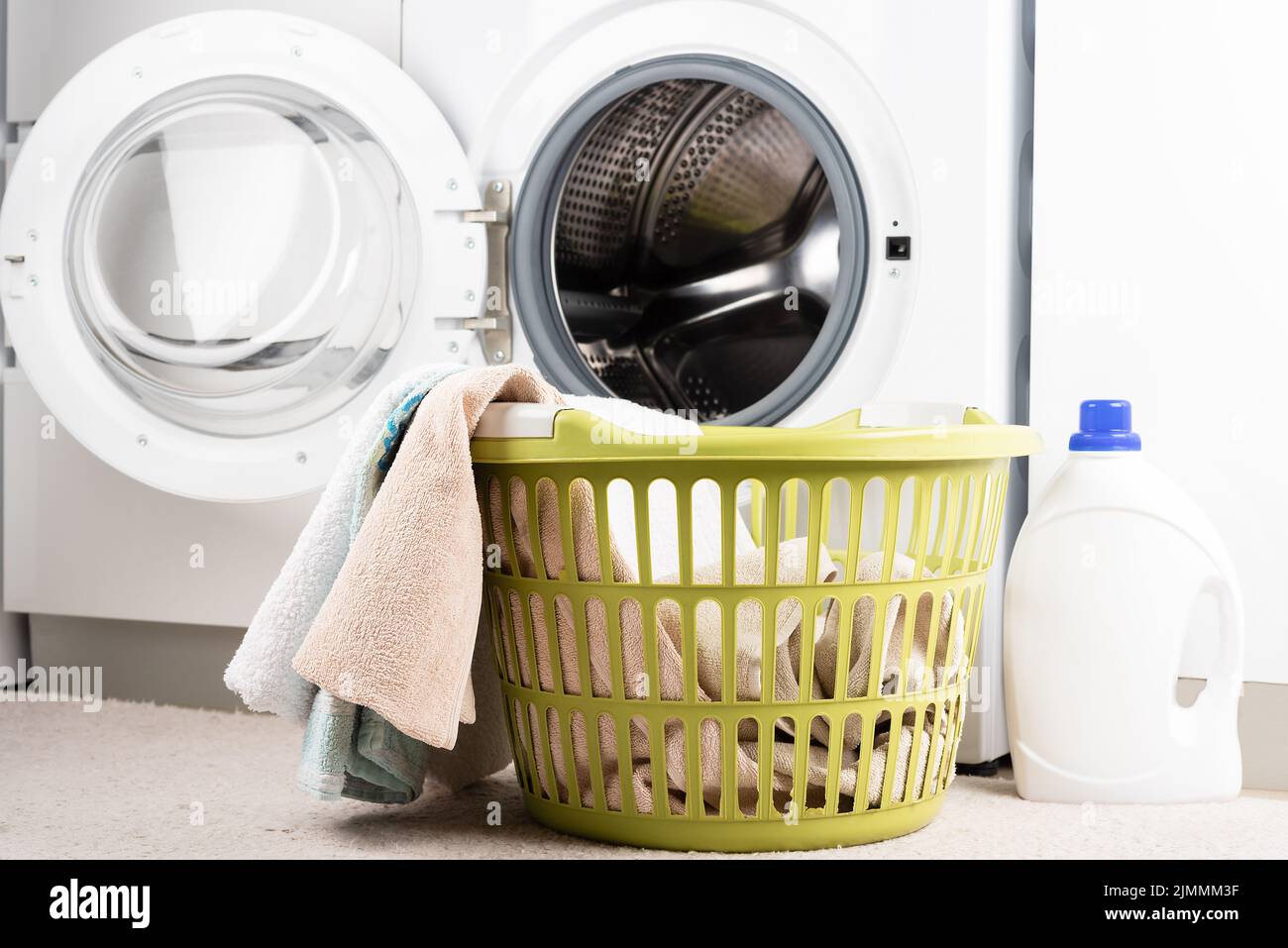 Laundry basket, liquid detergent and washing machine. Stock Photo