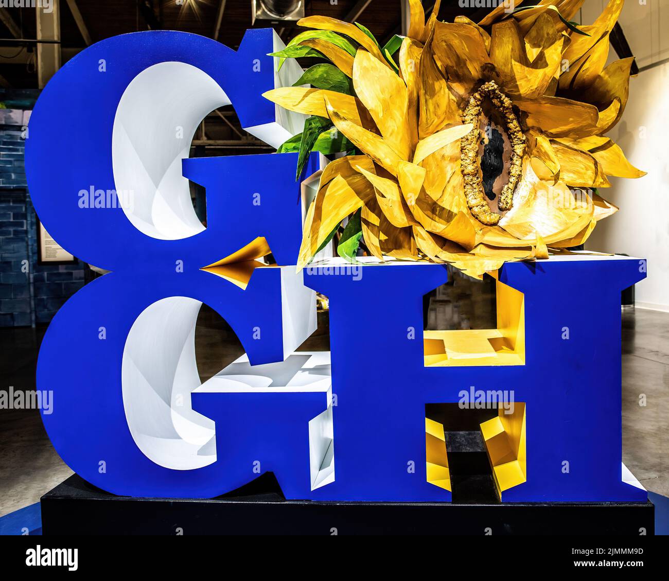 Big blue letters spelling out Gogh with the O being a sunflower which Vincent Van Gogh is famous for painting. Stock Photo