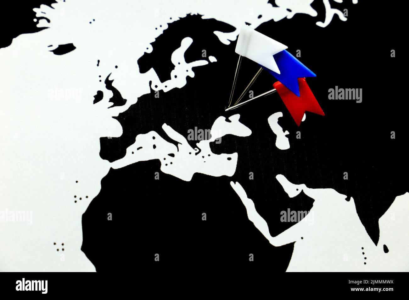 White, Blue and Red pointing flags on Ukraine country on black world map Stock Photo