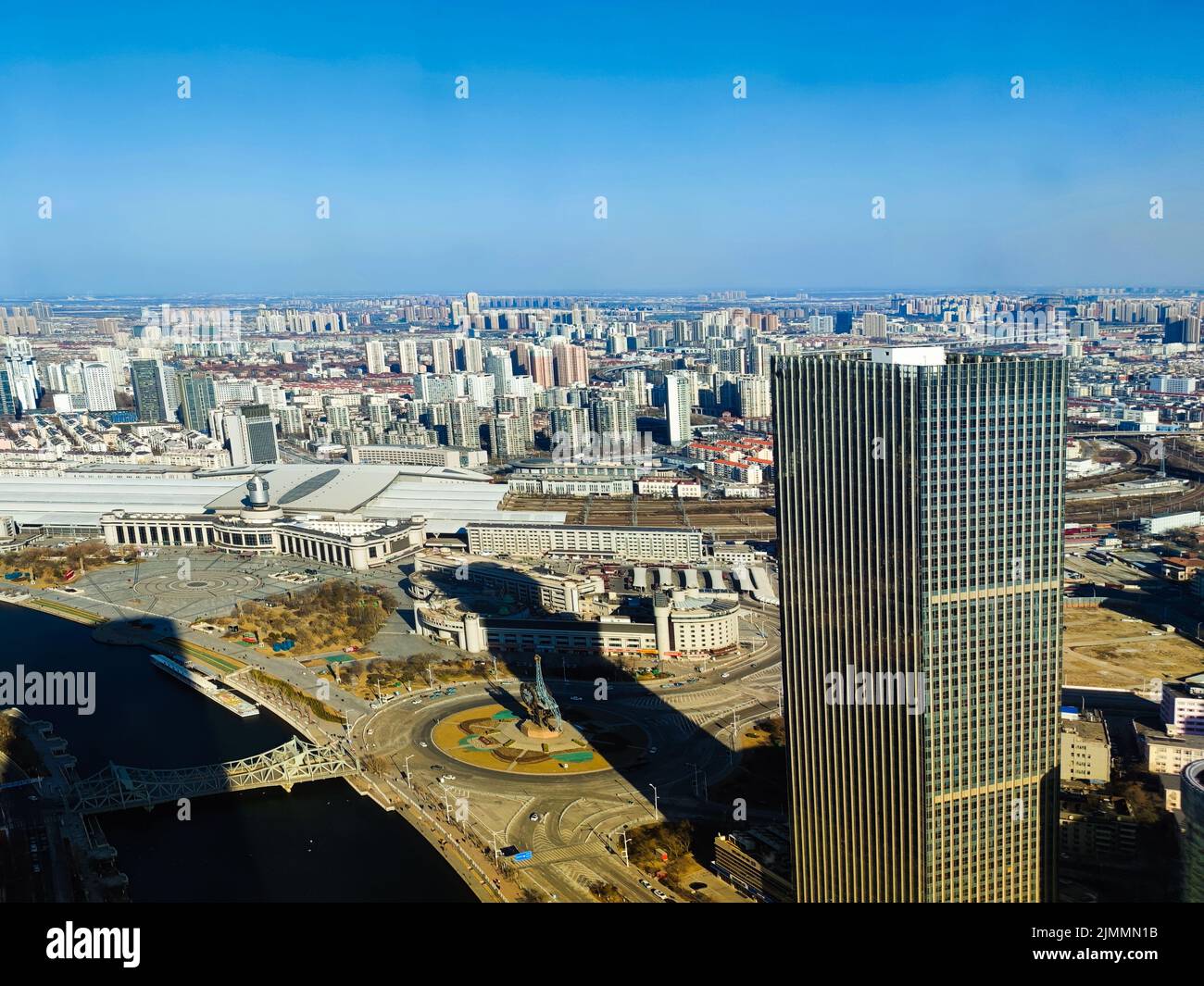 An aerial view of a city with white tall buildings and a modern ...