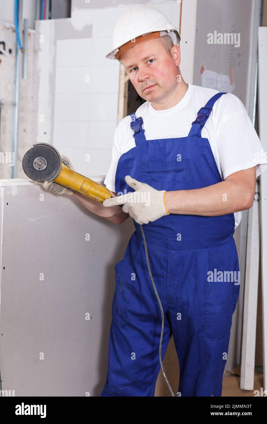 Contractor using angle grinder Stock Photo