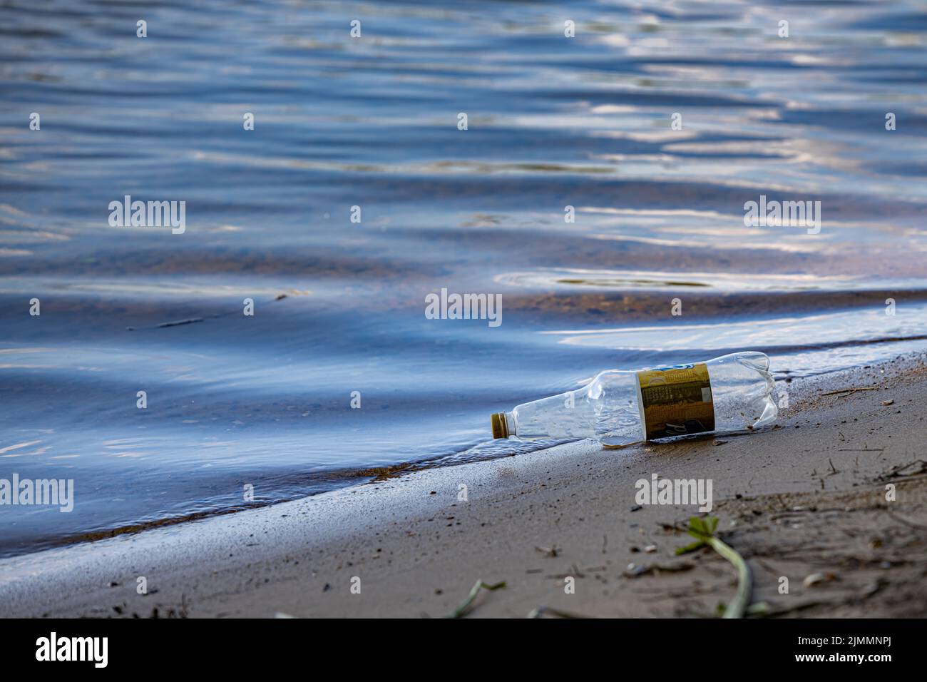 Moscow, Russia - July 21, 2022: empty plastic bottle lying on the shore. High quality photo Stock Photo