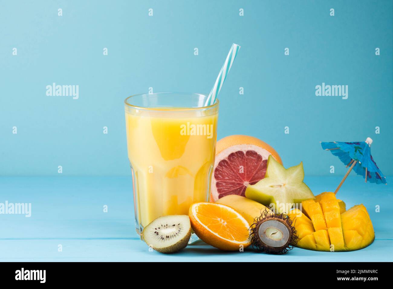 Summer fruit juice blue background Stock Photo